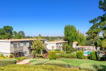 An aerial view of apartments with lawns and trees